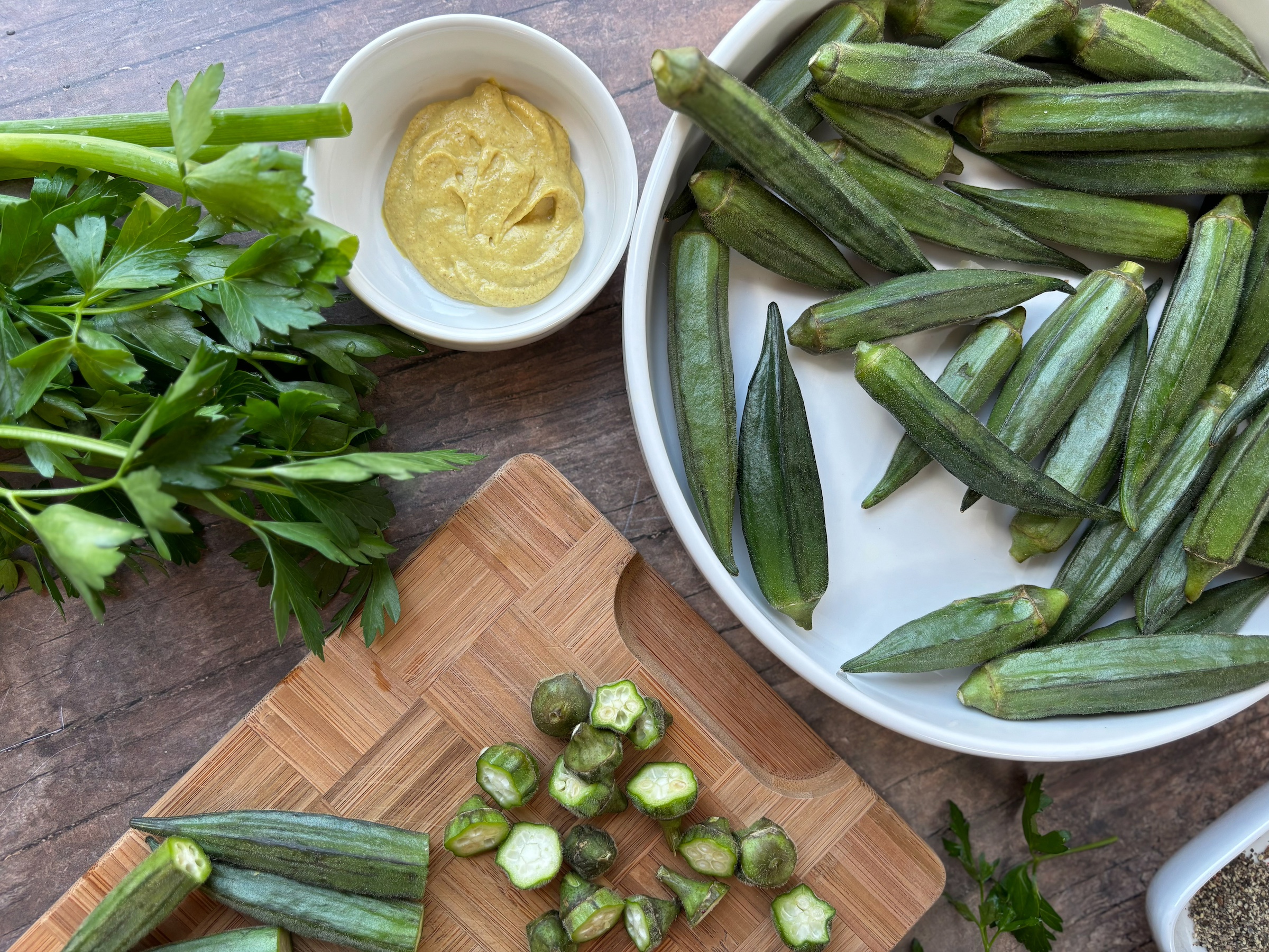 Baked okra bites prep on a cutting board. 