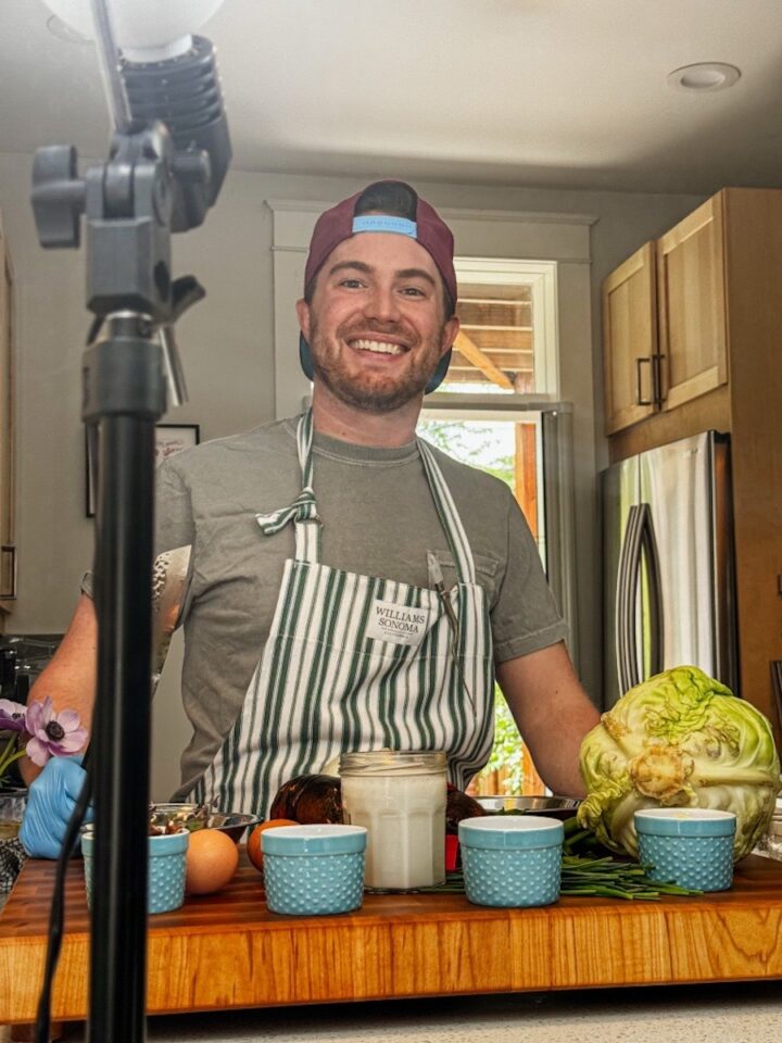 Photo of Elliot Baron cooking in a kitchen.