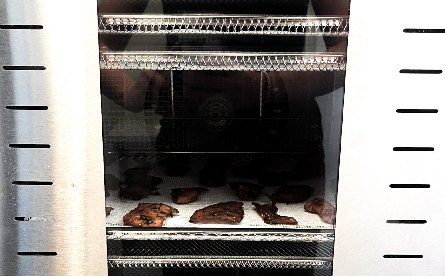 Homemade raspberry pork jerky in the dehydrator.