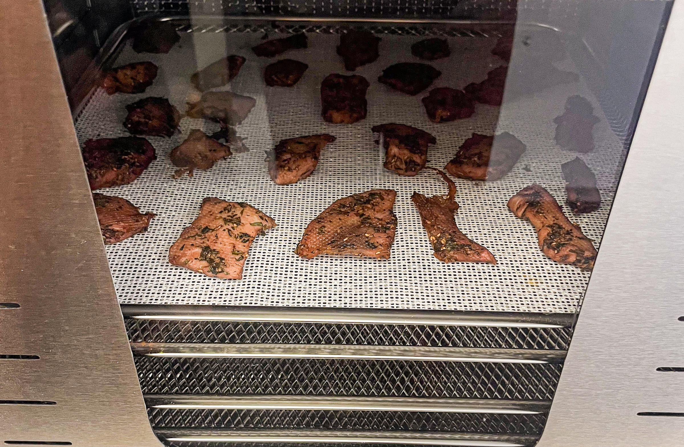 Homemade raspberry pork jerky close up in the oven. 
