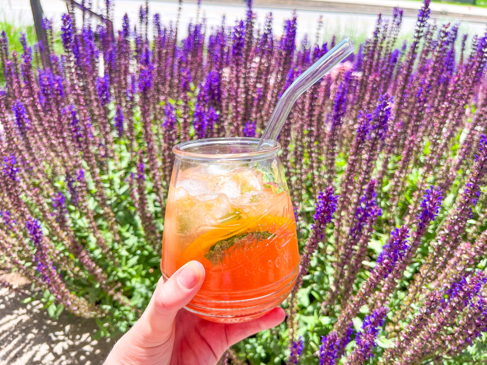 Honey citrus mint tea finished in a single glass outside.
