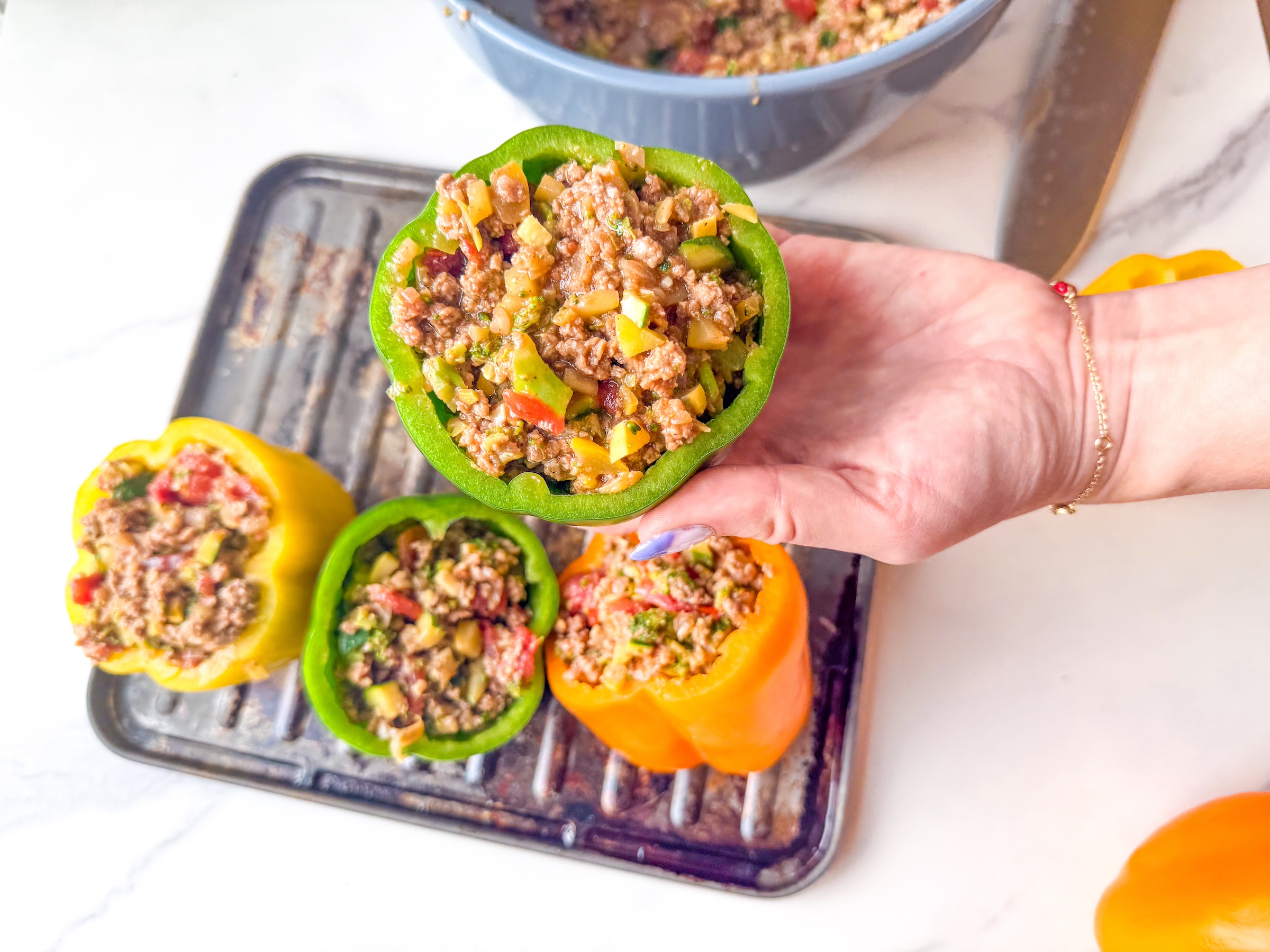 Paleo stuffed peppers on a cooking tray. 