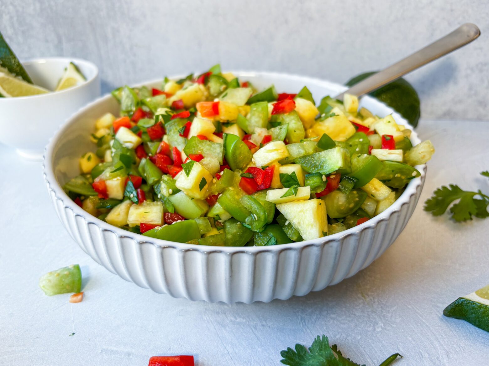 Grilled pineapple salsa verde finished in a bowl.
