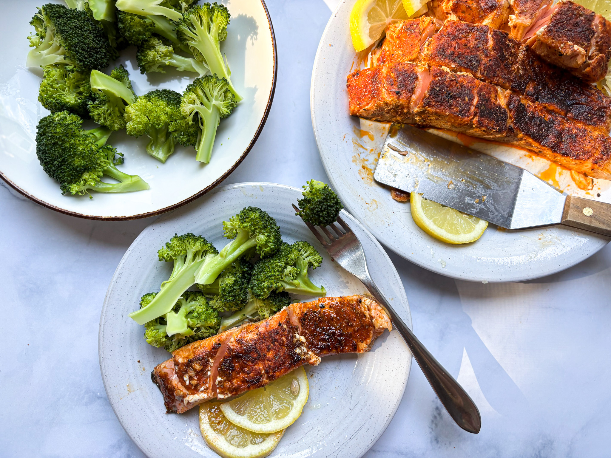 Blackened salmon from above, with a plate of broccoli and salmon fillets. 