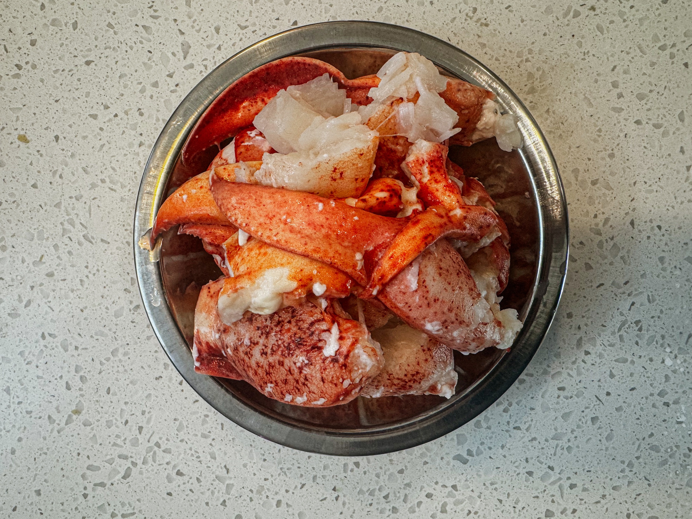 Lobster roll preparation, lobster meat in a bowl.