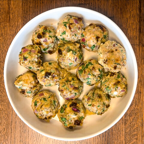 Mediterranean Chicken Meatballs finished in a wide, white bowl.