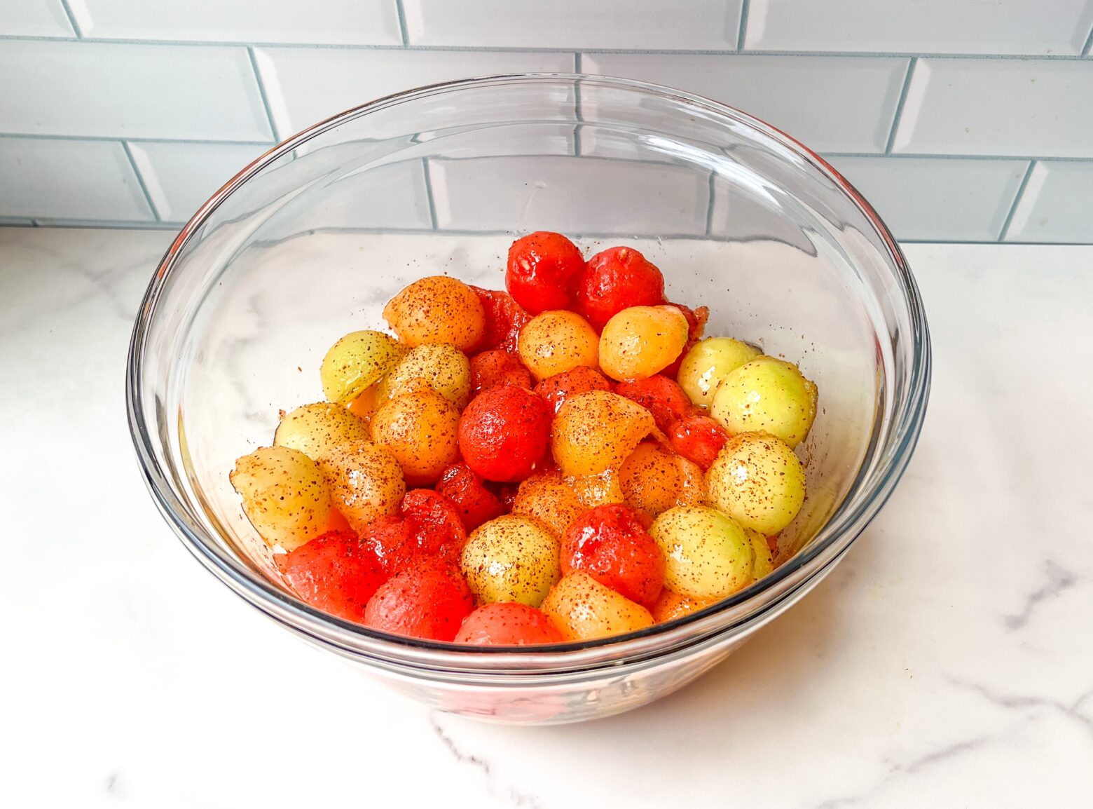 Melon fruit salad, finished in a bowl from a side view.