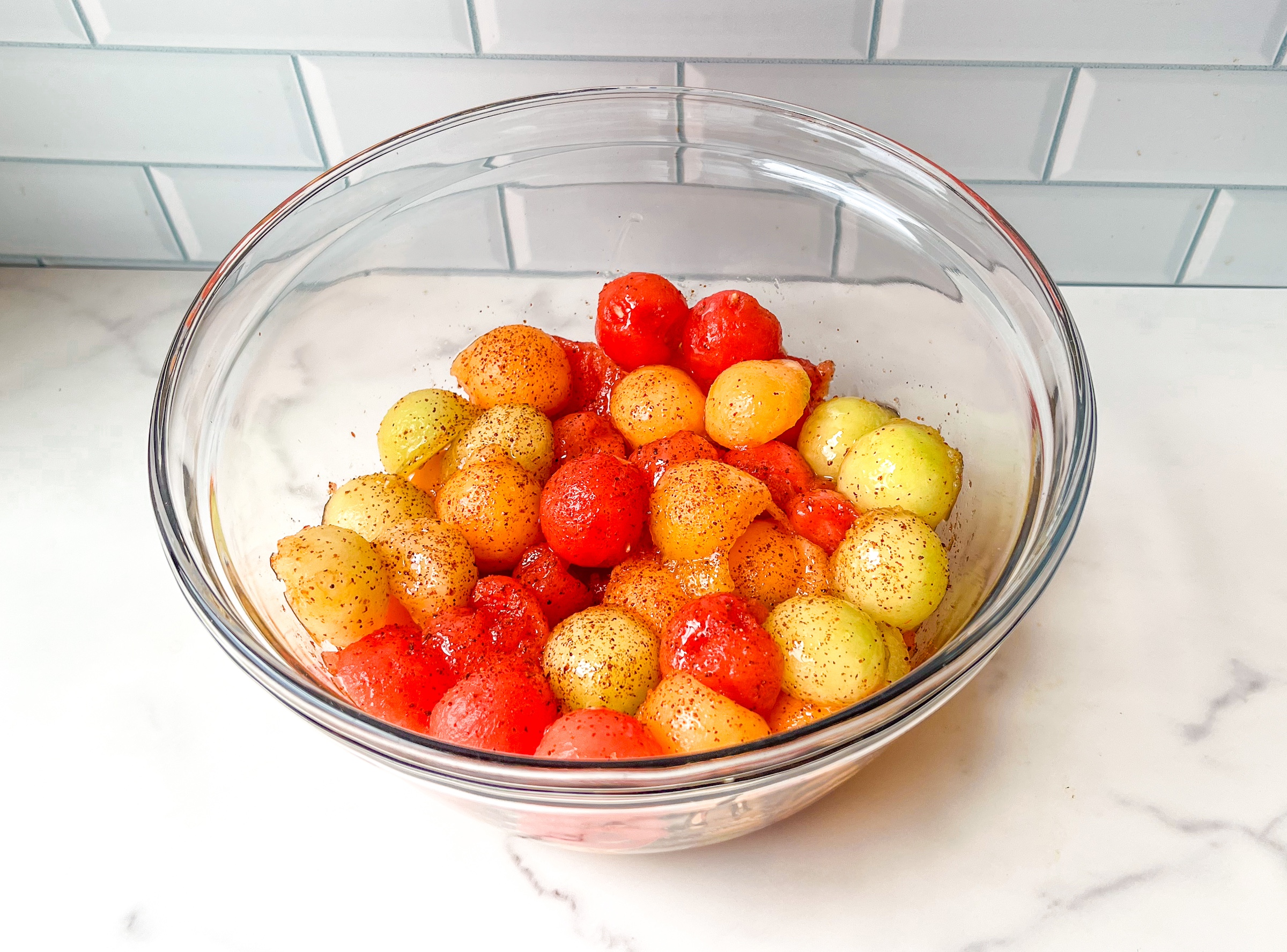 Melon fruit salad, finished in a bowl from a side view. 