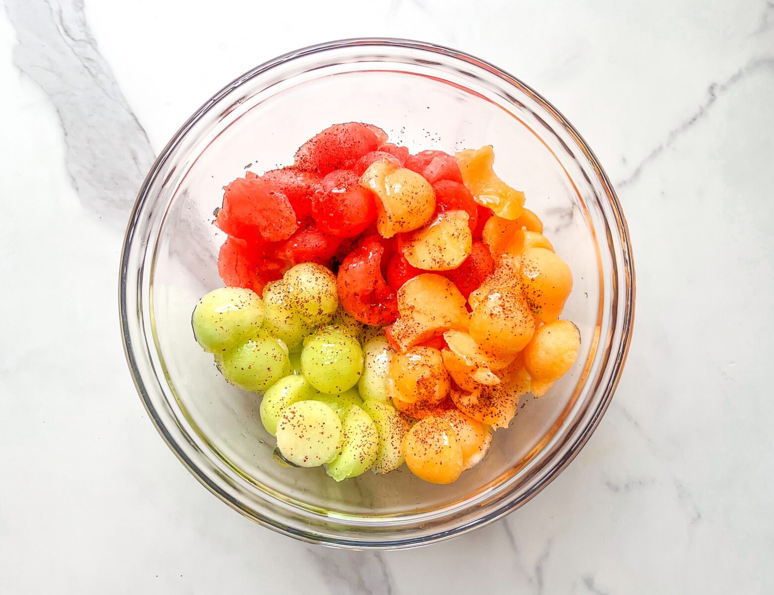Melon fruit salad finished, in a bowl from an above view.