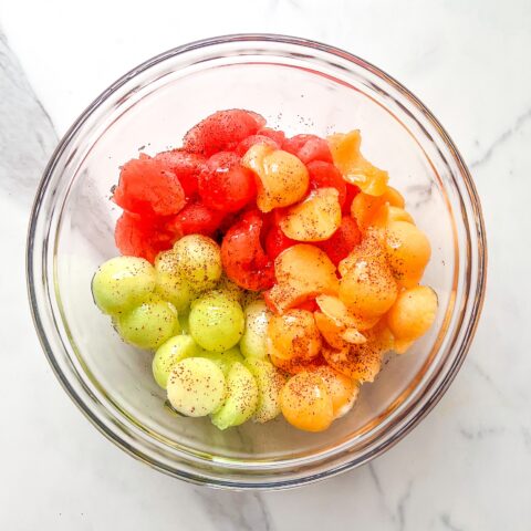 Melon fruit salad finished, in a bowl from an above view.