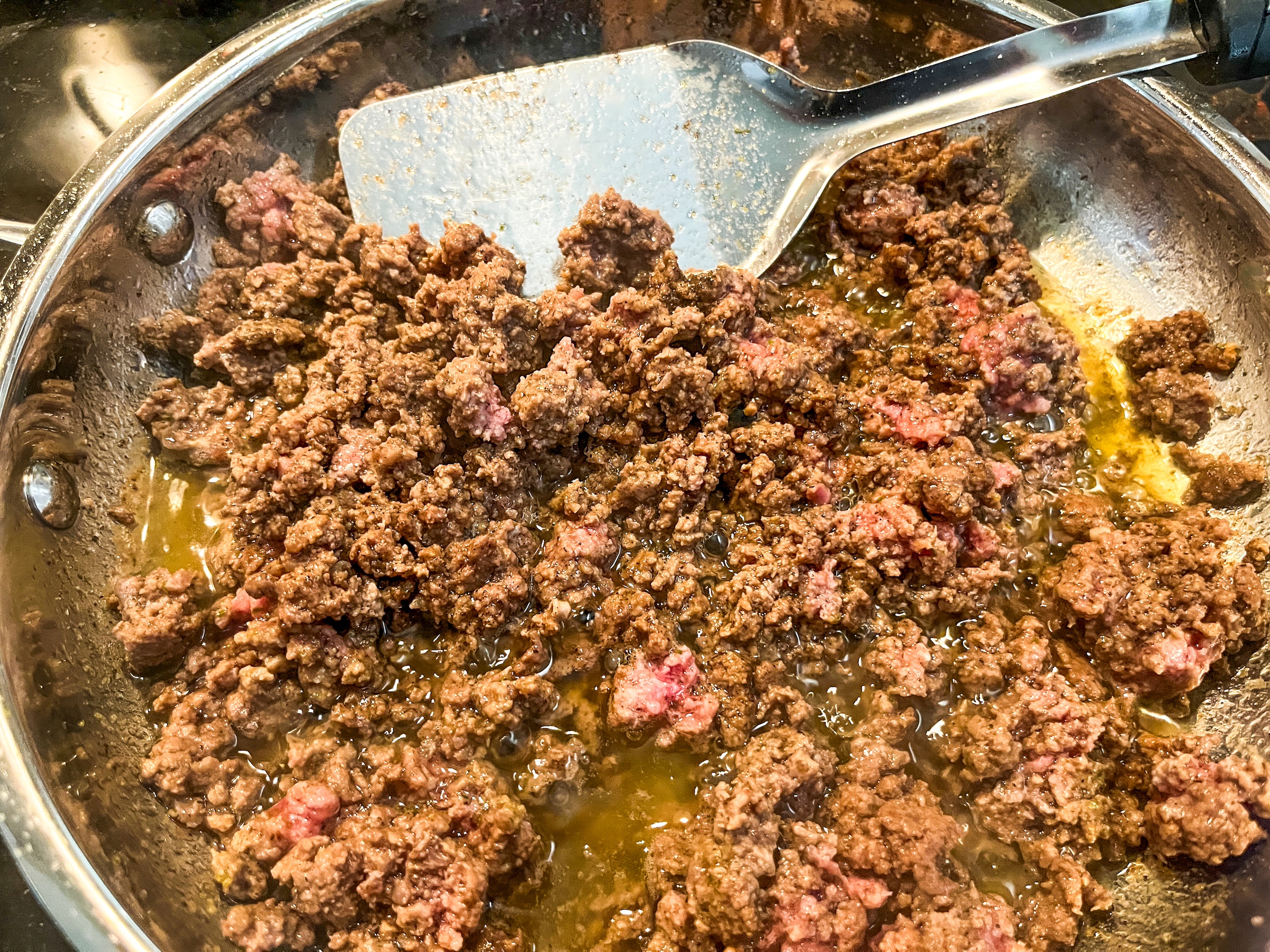 Ground beef protein bowl beef being cooked over the stove. 