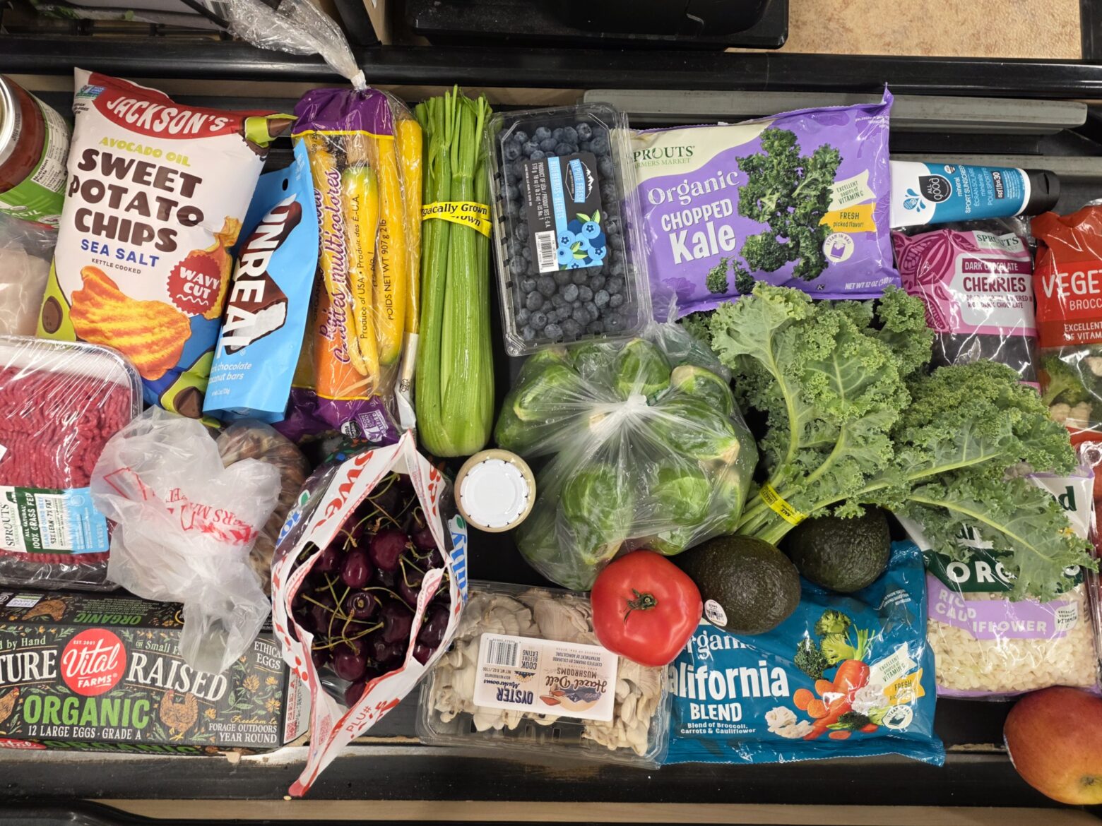 Overhead shot of healthy groceries on a conveyor belt