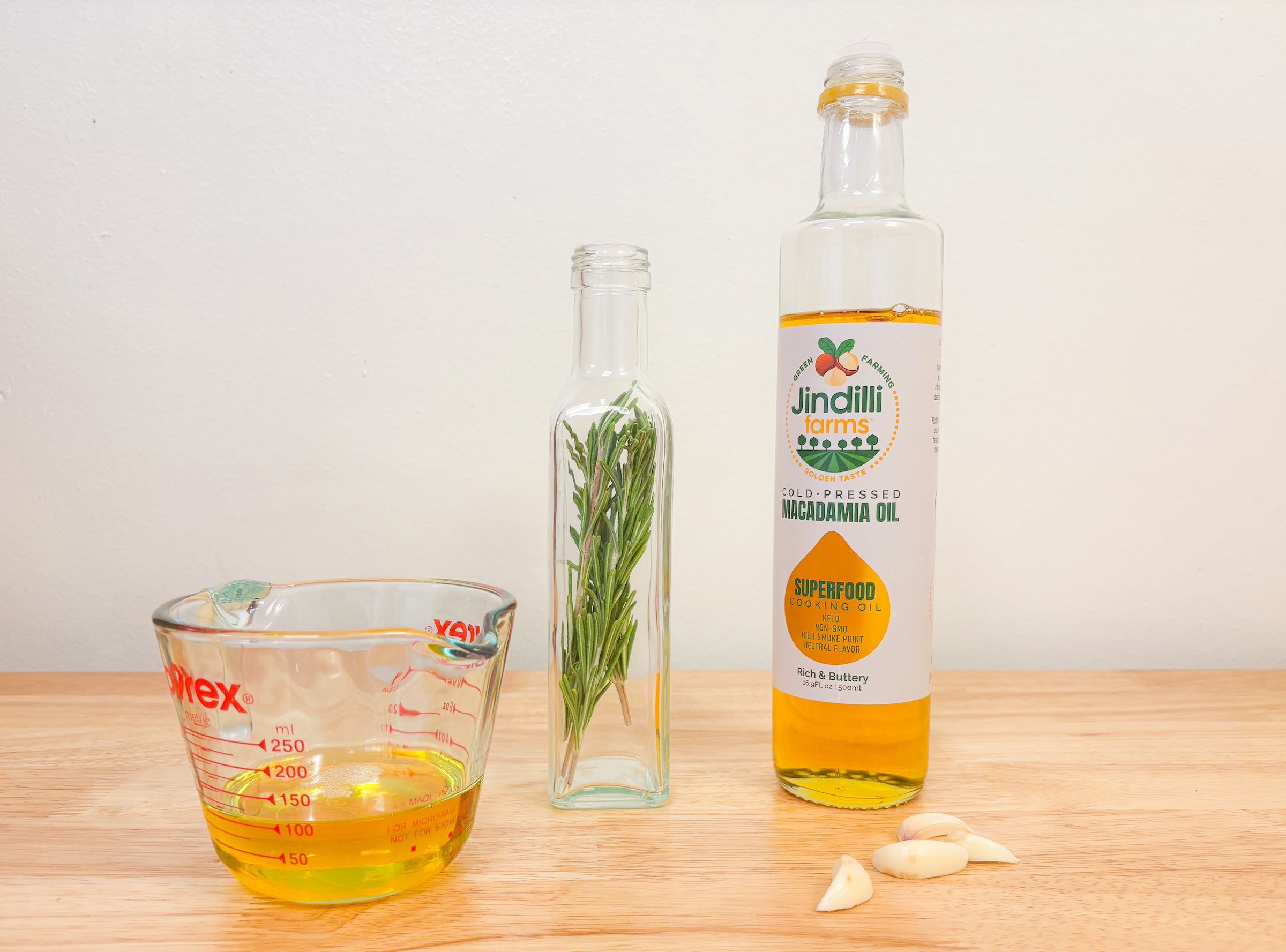 Infused macadamia nut oil ingredient prep on a table. 