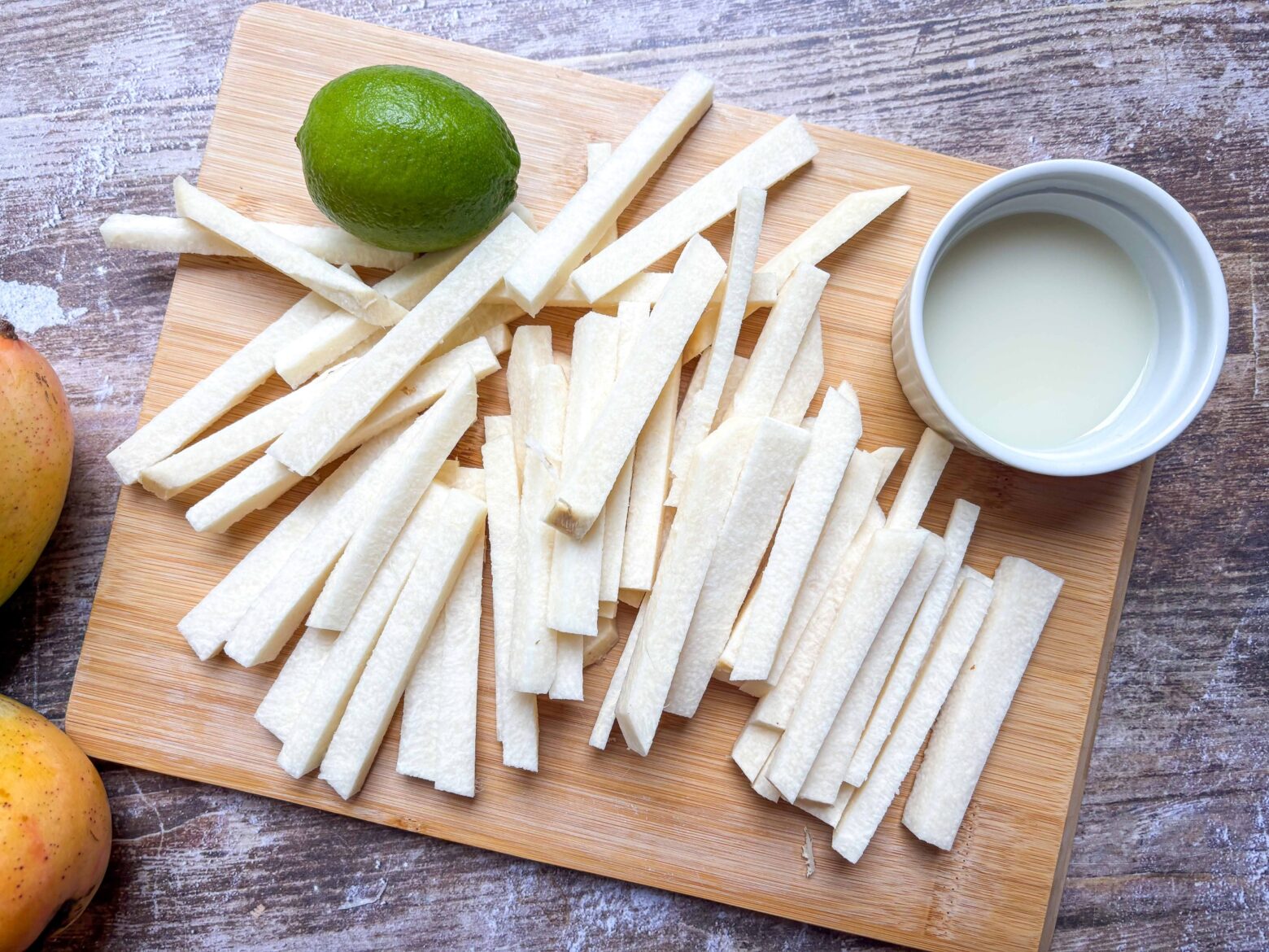 Jicama sticks prepped on a cutting board