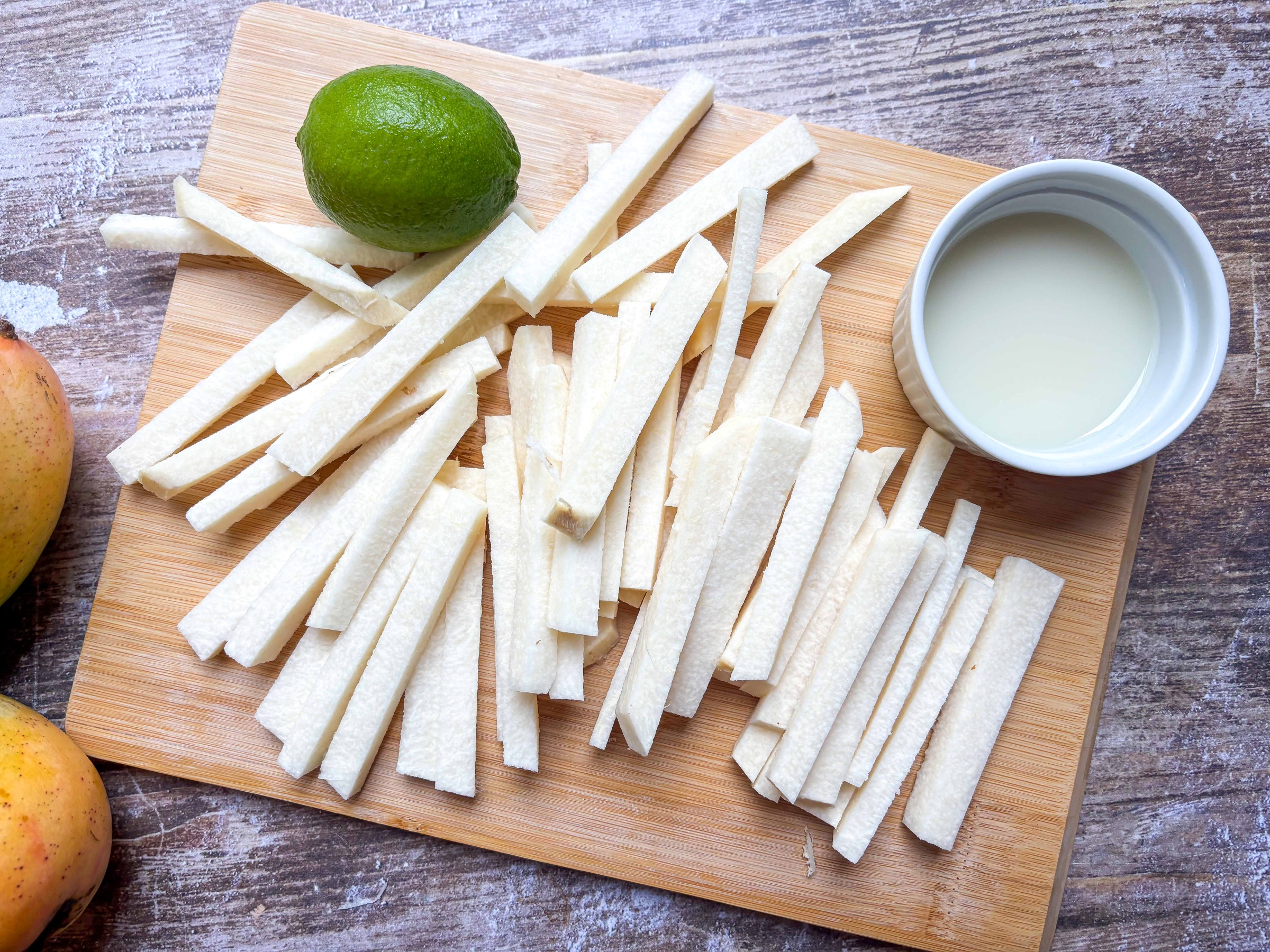 Jicama sticks prepped on a cutting board
