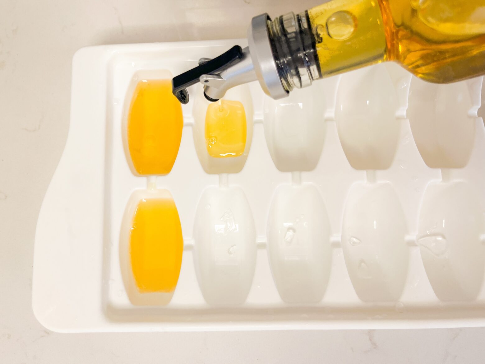 Infused macadamia nut oil in an ice cube tray.