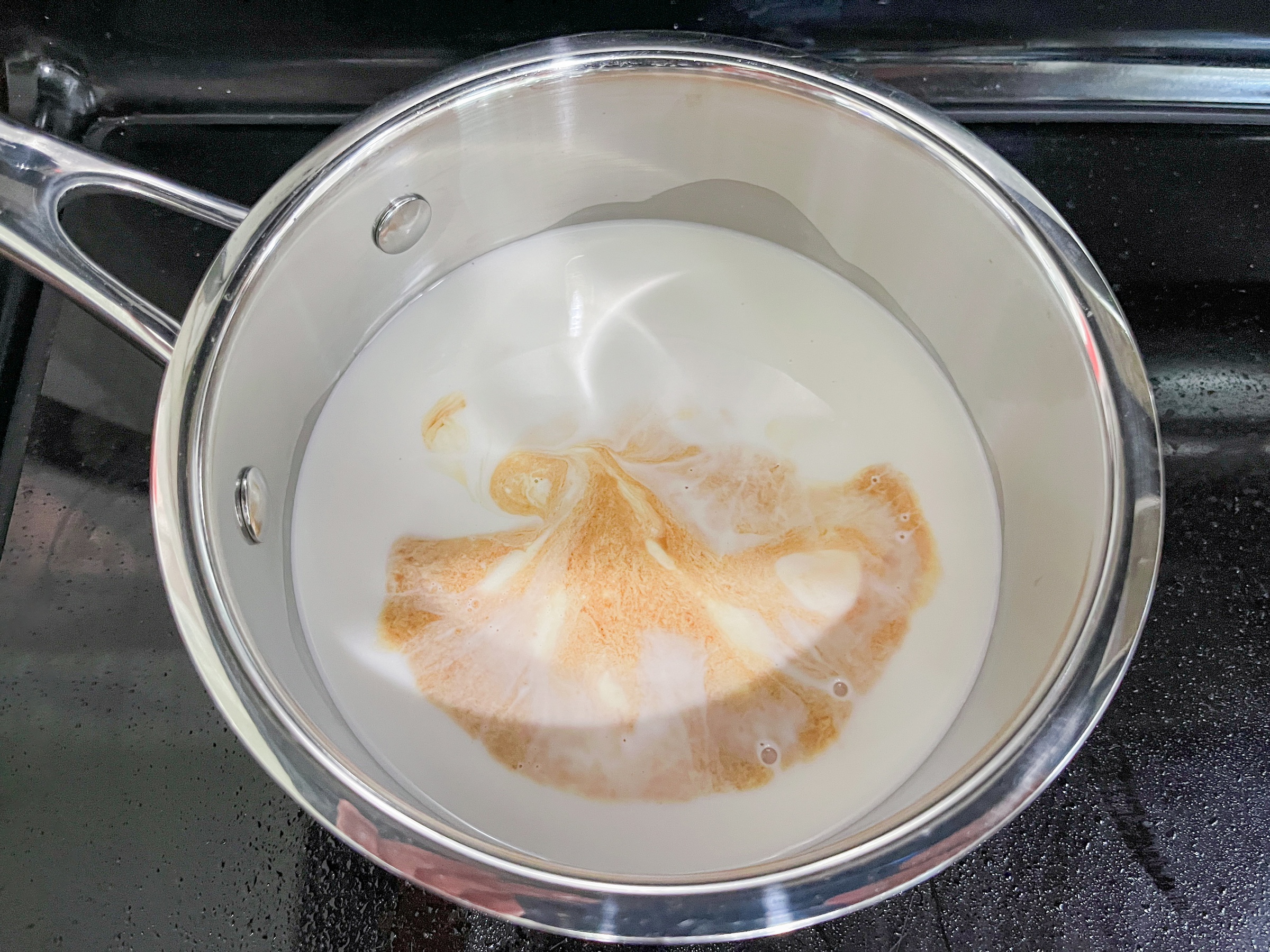 Heating ingredients for matcha pudding up on the stove. 