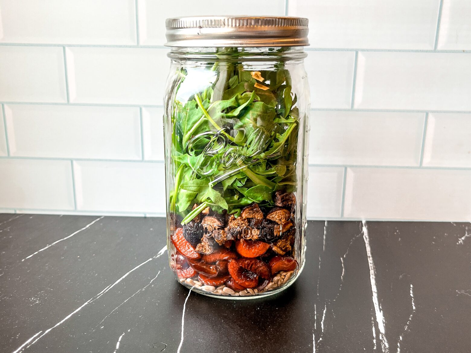 Summer mason jar salad finished, in a mason jar.