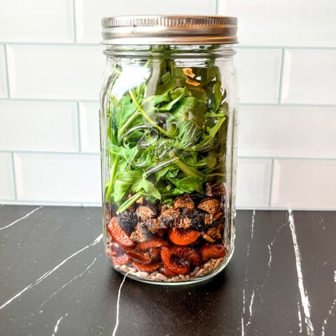 Summer mason jar salad finished, in a mason jar.