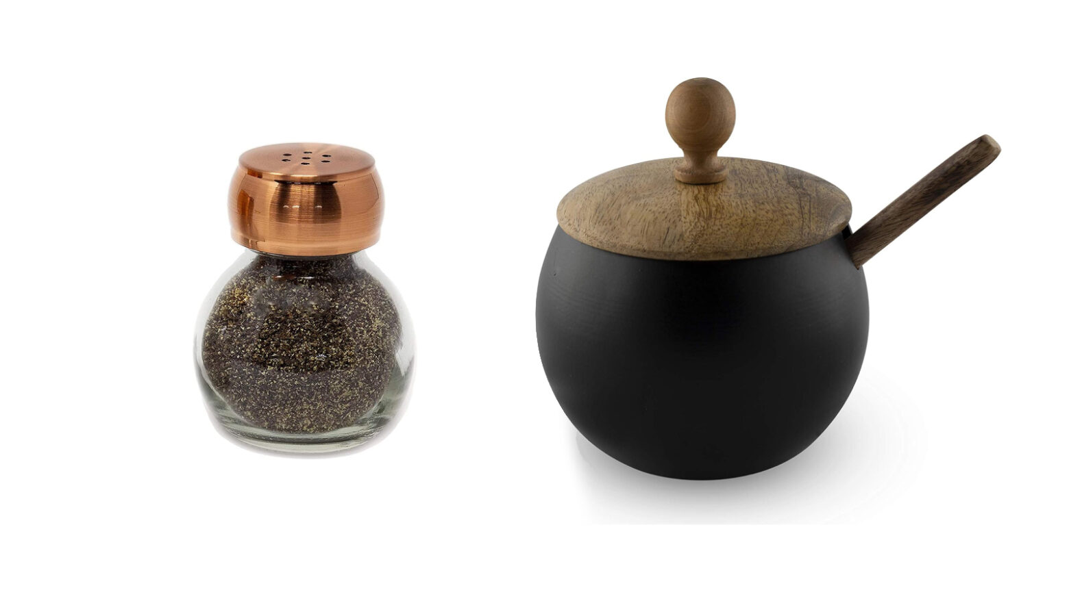 A glass and copper pepper shaker next to a round, black sugar bowl with wooden spoon.
