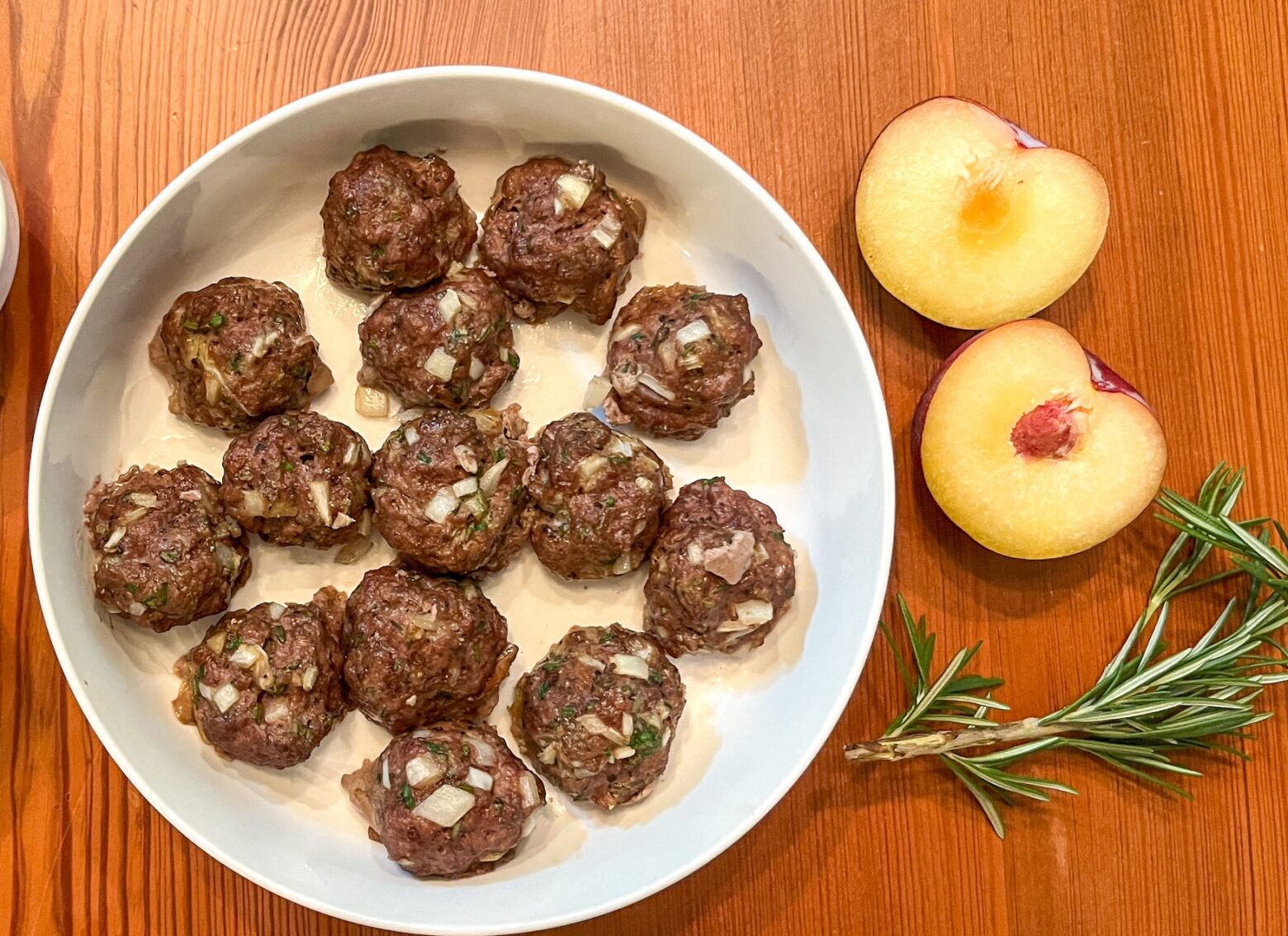 Bison meatballs finished with side sauces.
