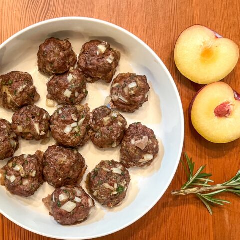 Bison meatballs finished with side sauces.