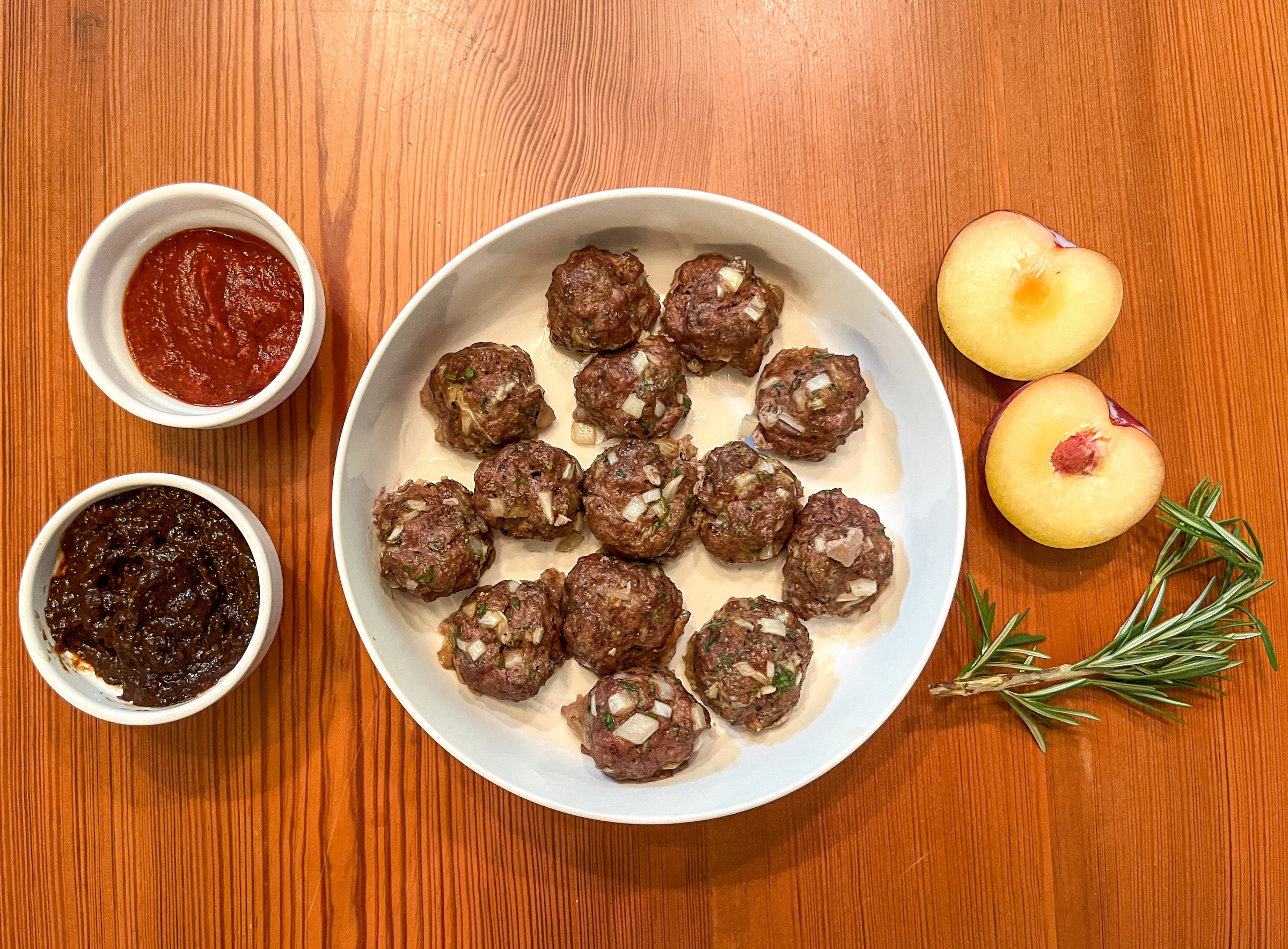 Bison meatballs finished with side sauces. 