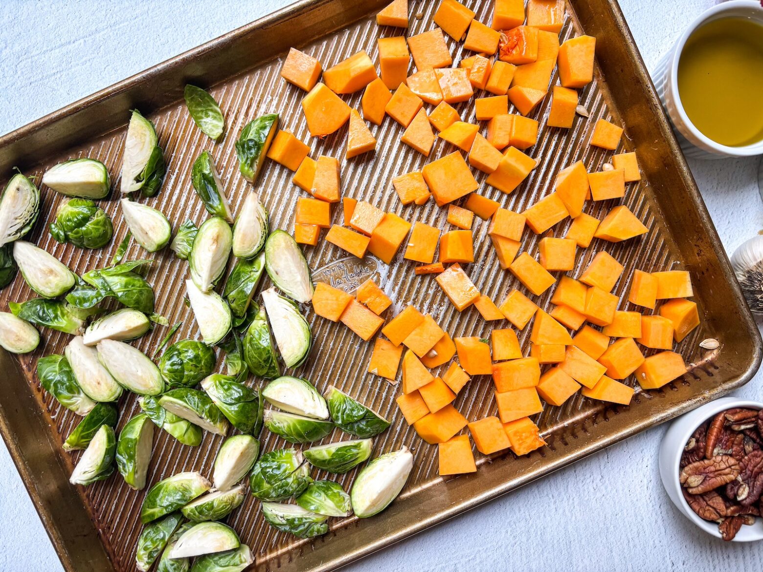 Harvest protein bowl prep on a baking sheet.