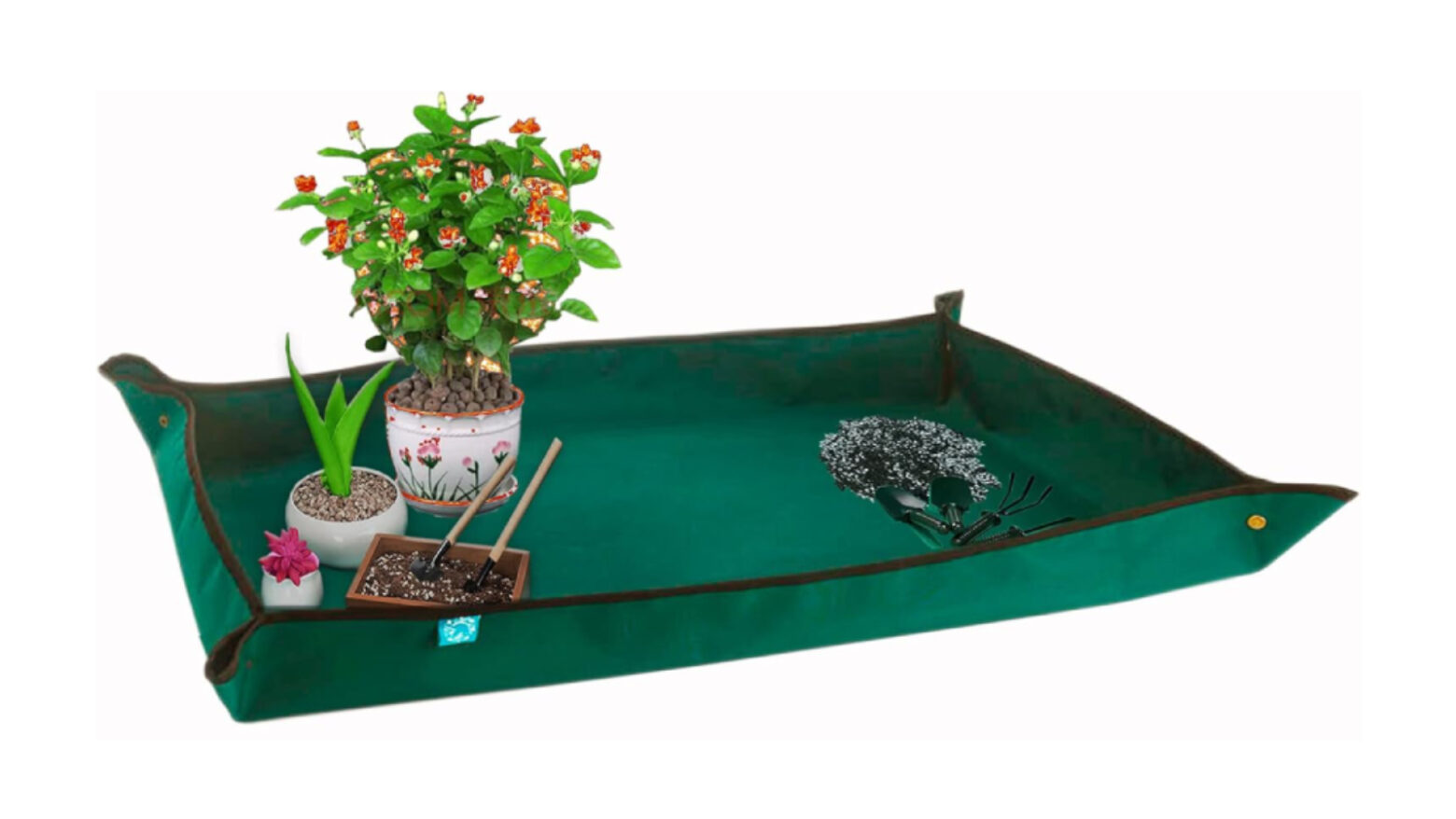 Green potting mat holding gardening tools and plants