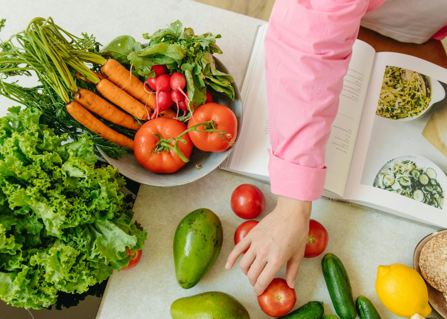Fruits and vegetables on in a bowl on the counter.
