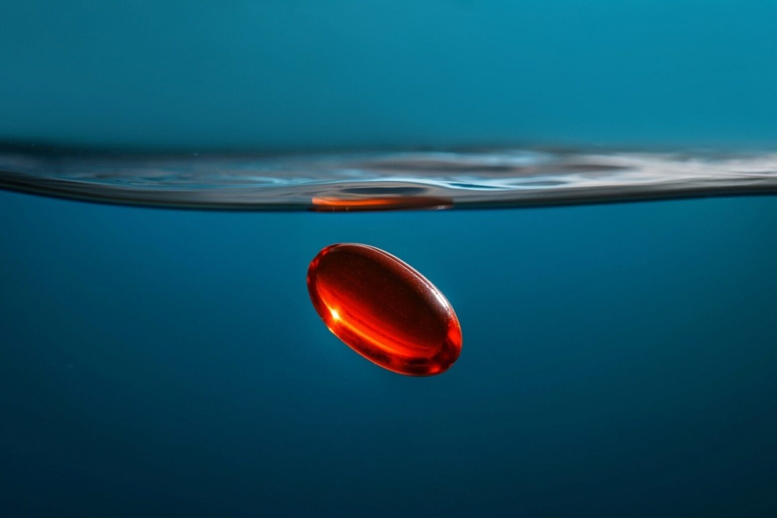 Computer-generated image of a red gel supplement sinking underwater