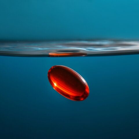 Computer-generated image of a red gel supplement sinking underwater