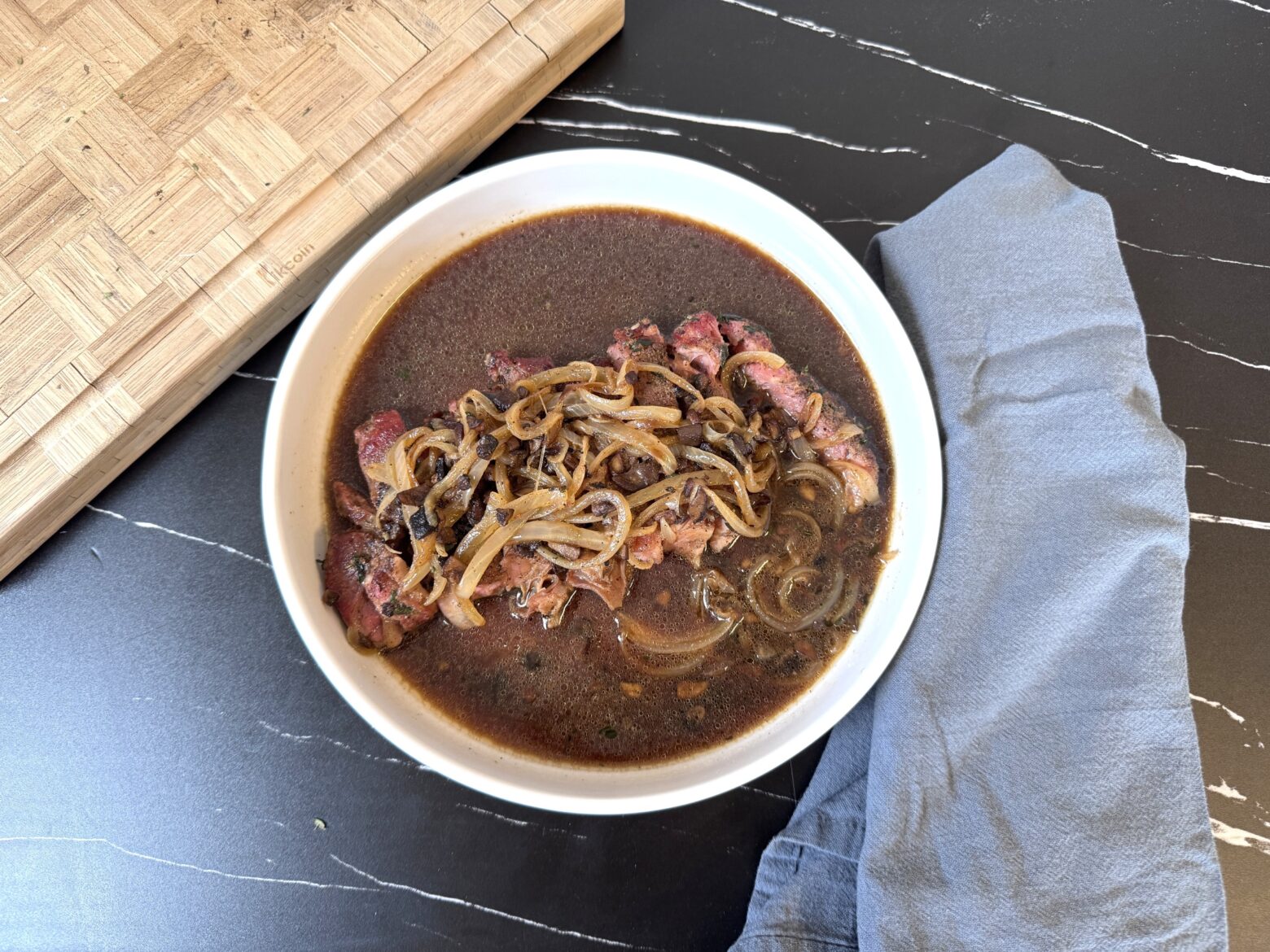 Above shot of plated French Onion Steak.