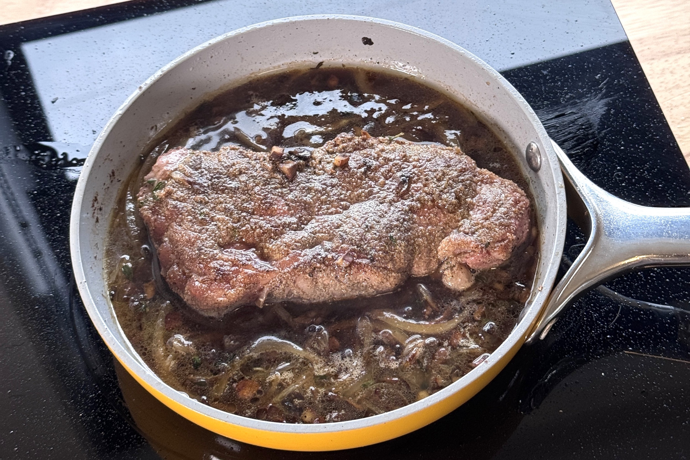 Steak simmering in mushroom-onion sauce.