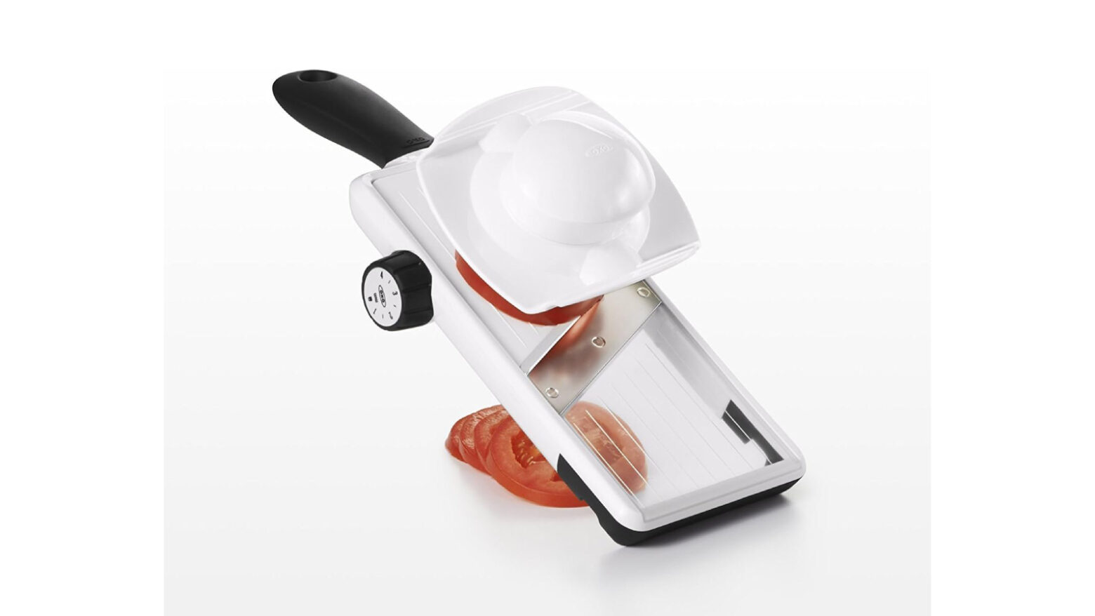 Mandoline with sliced tomato.