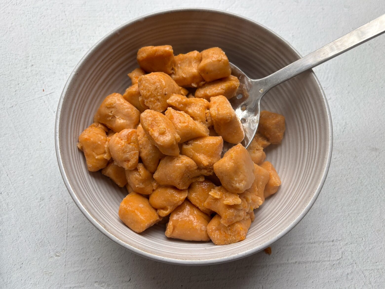 Sweet potato gnocchi finished in a bowl.