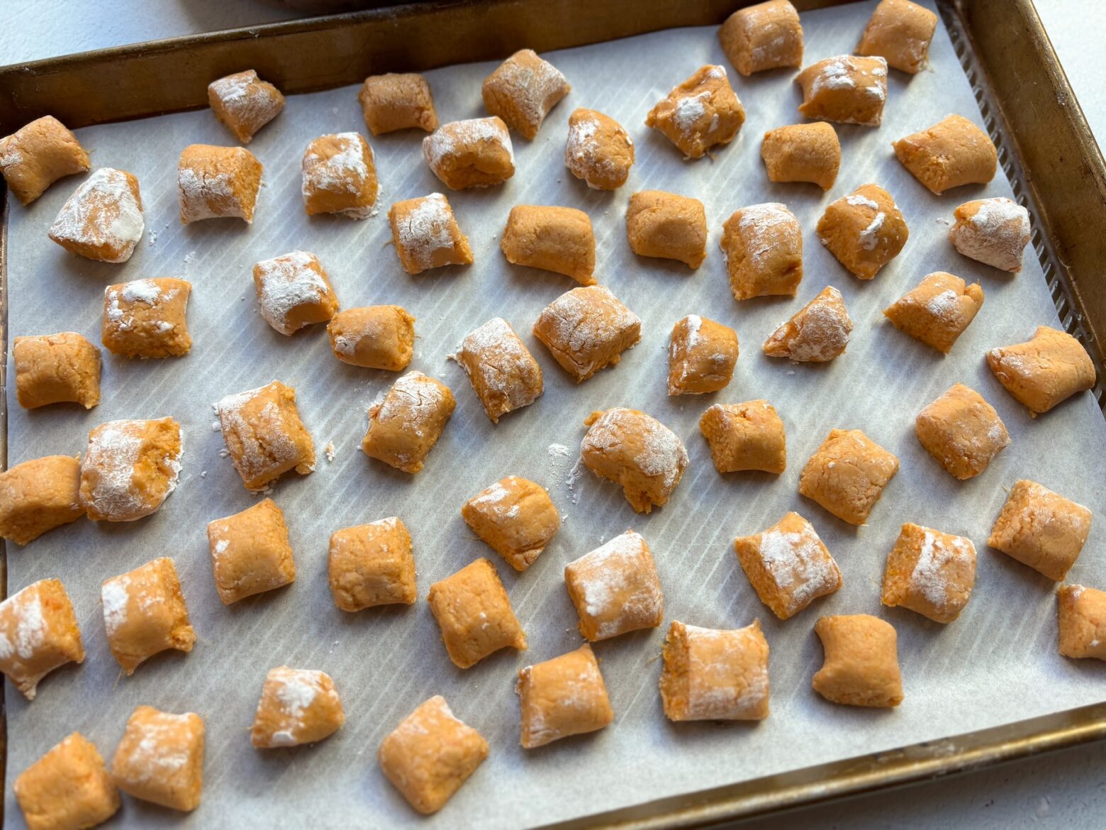 Sweet potato gnocchi on a baking tray pre-bake.