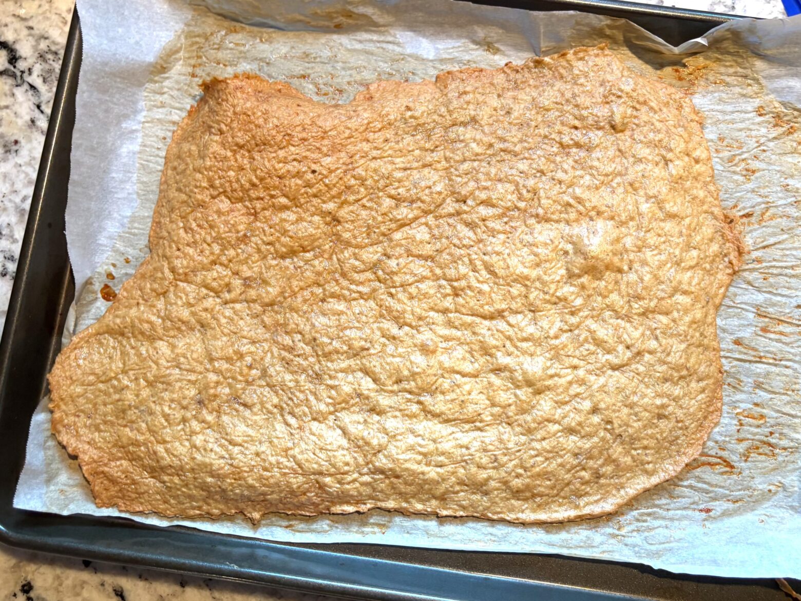 Cooked chicken chip mixture on a baking sheet.