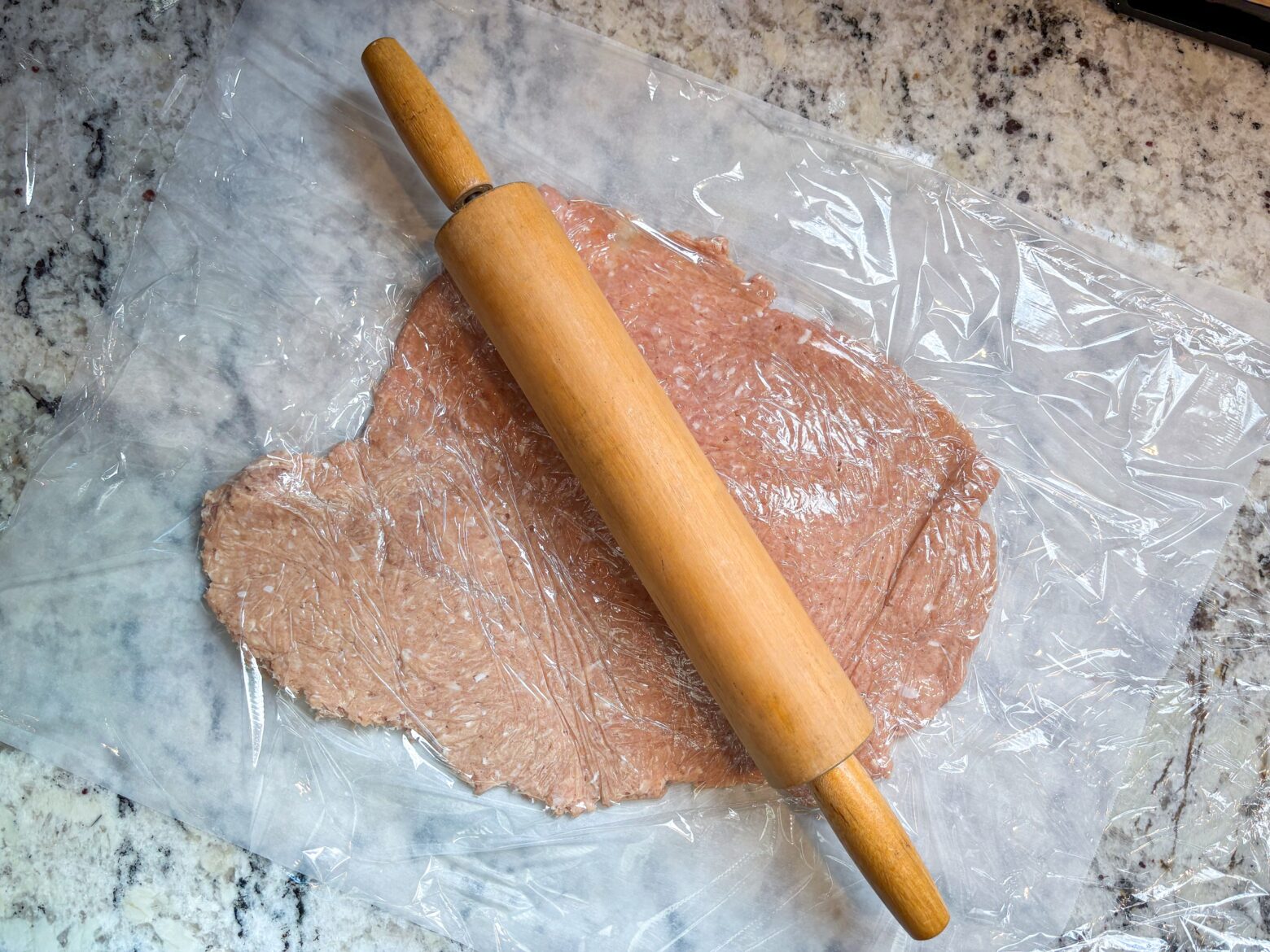 Rolling out chicken chip mixture with a rolling pin.