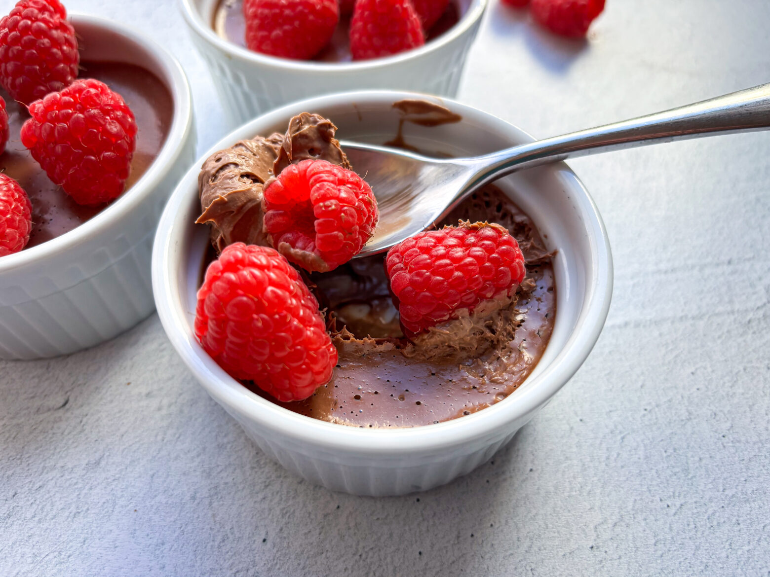 Chocolate Pots de Creme with raspberries.