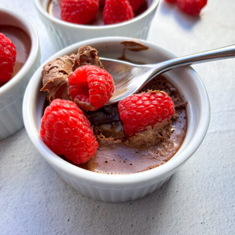 Chocolate Pots de Creme with raspberries.