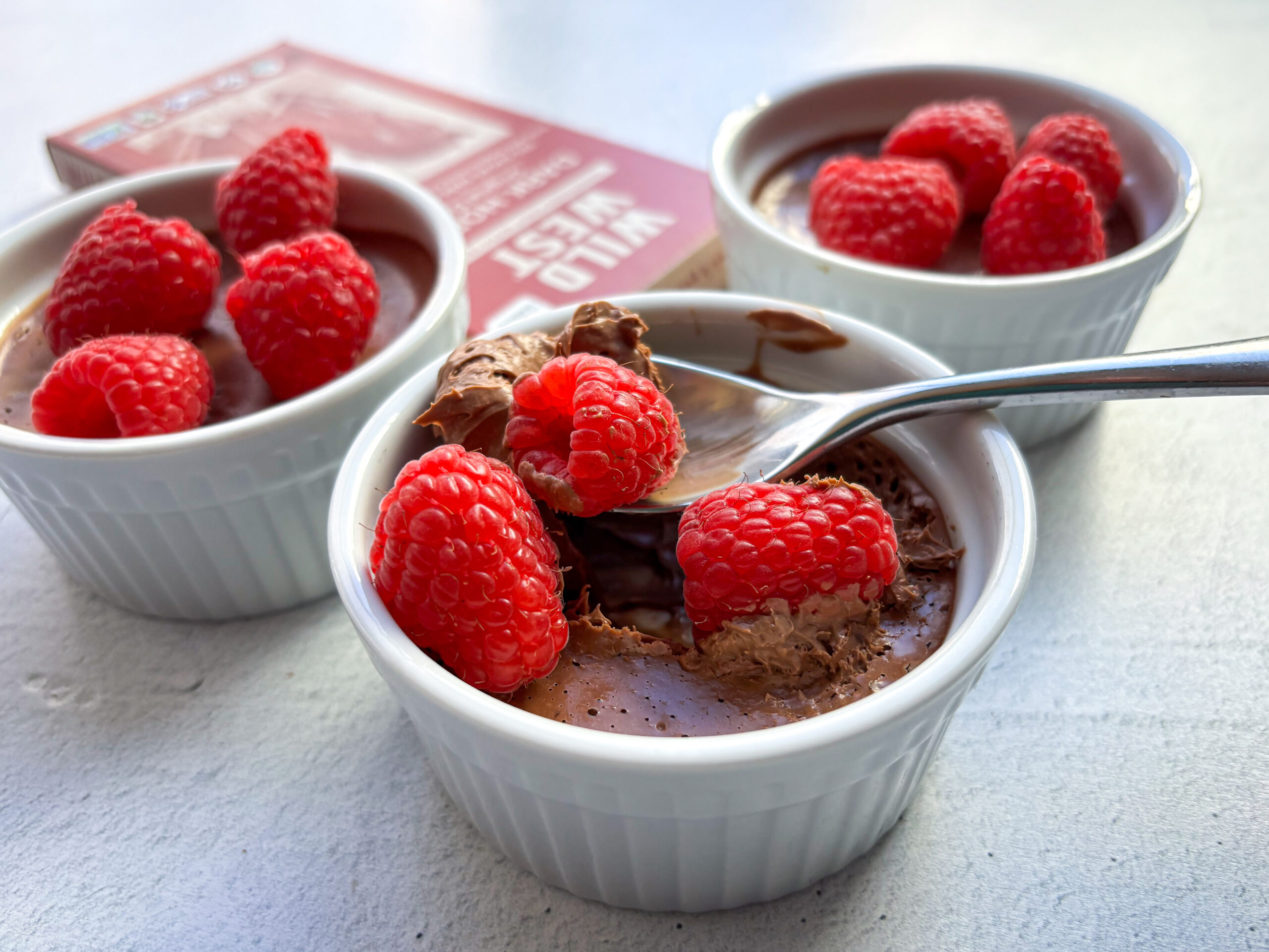 Finished Chocolate Pots de Creme with raspberries.