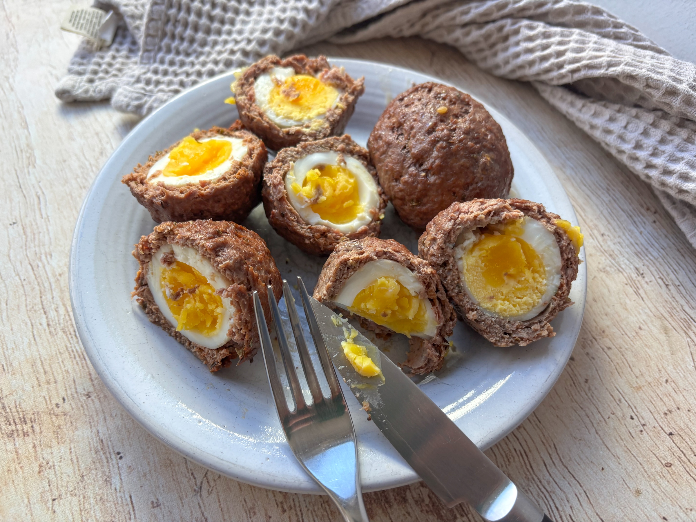 Eating Baked Scotch Eggs on a plate