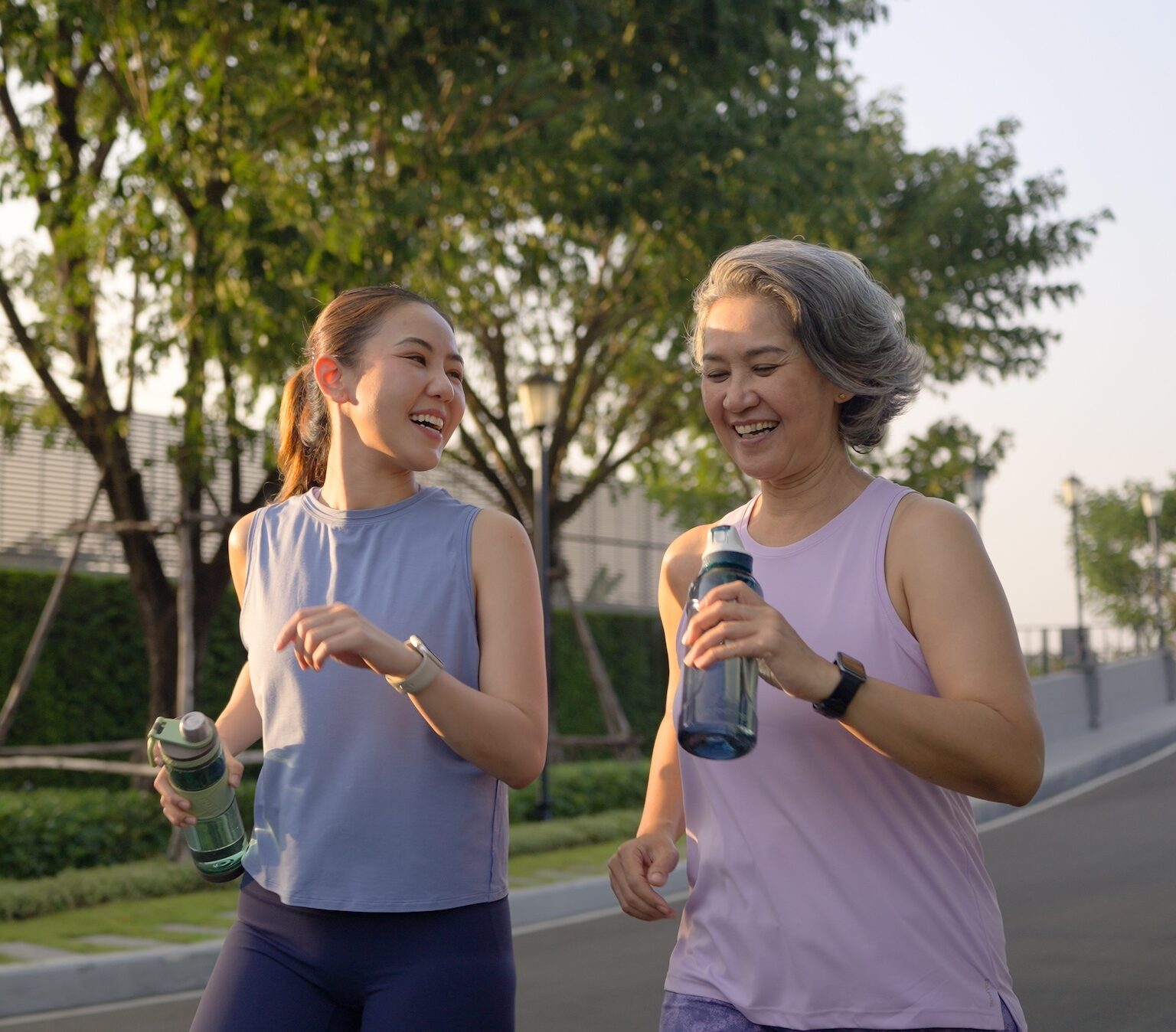 Two women running on the street.