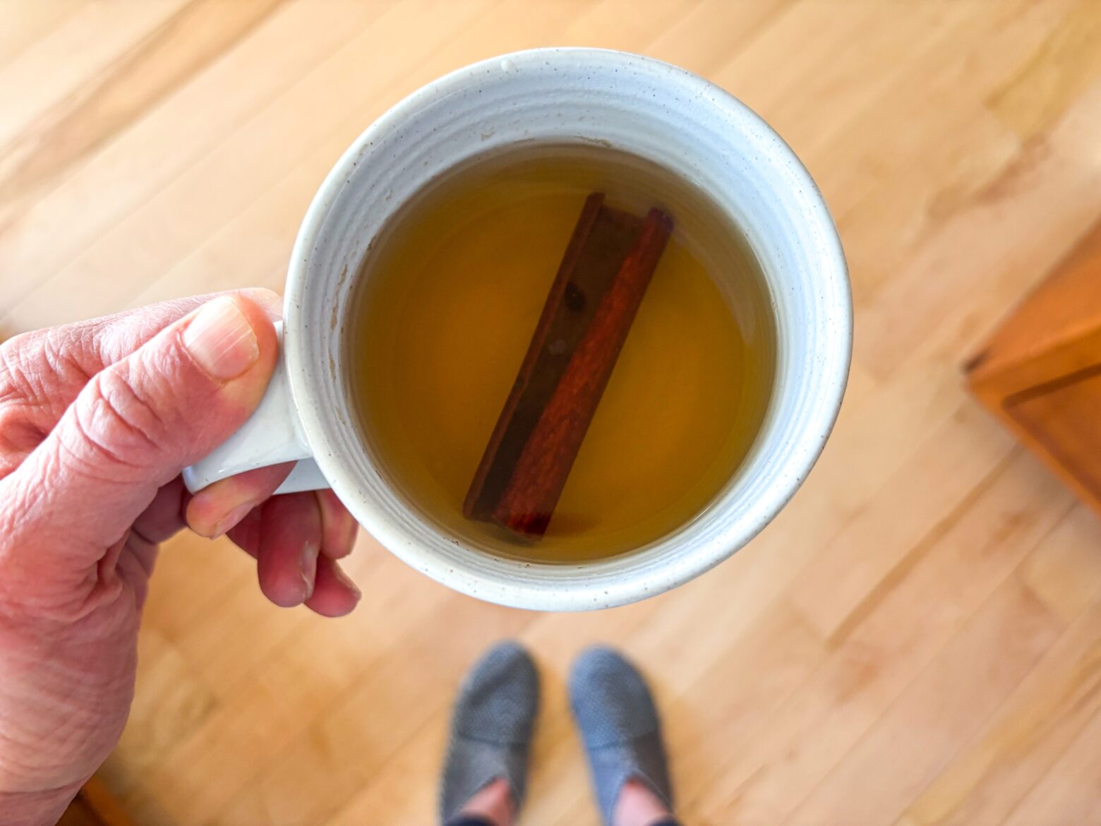Chamomile Cinnamon Tea in a mug with a cinnamon stick.