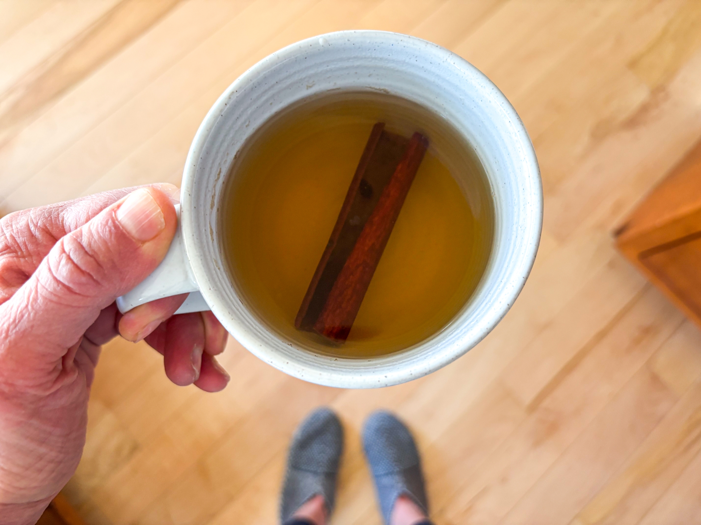 Chamomile Cinnamon Tea in a mug with a cinnamon stick.