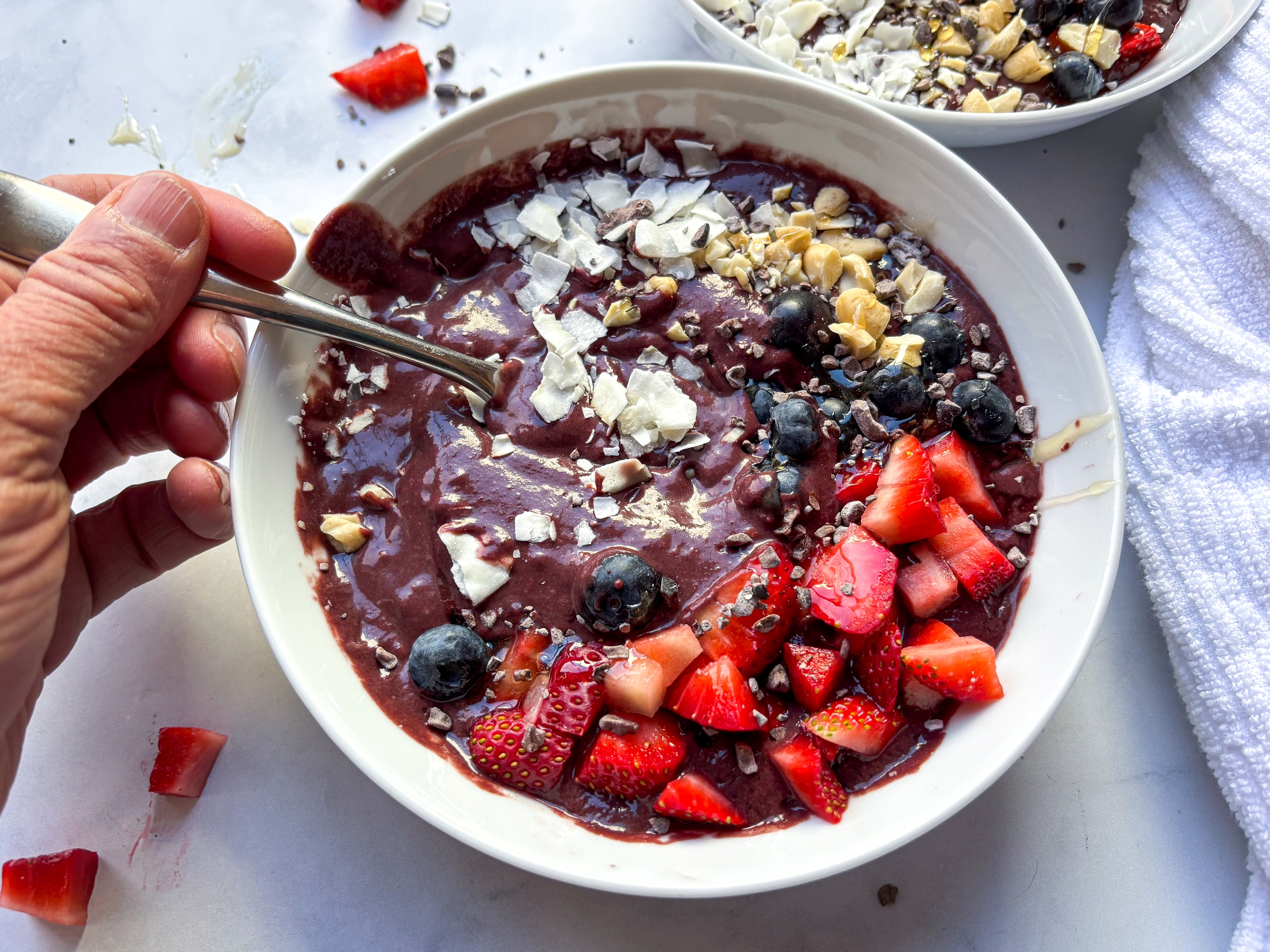 Acai bowl with a spoon dipped in it