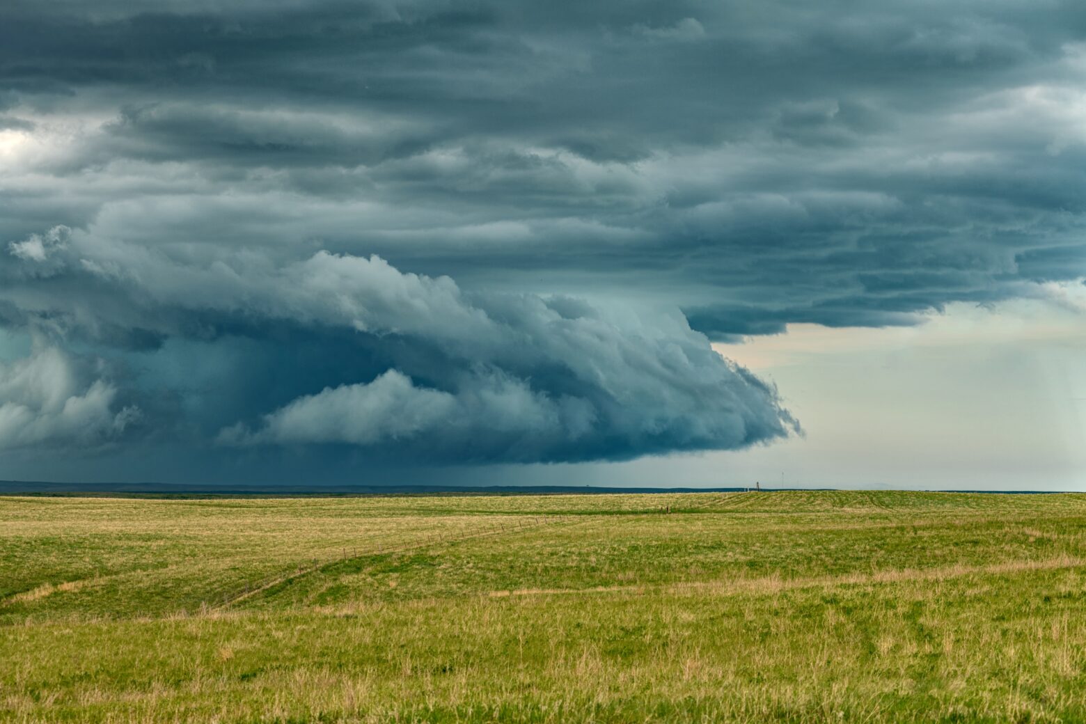 Storm clouds over grassy plains.