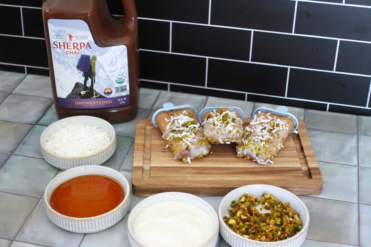 Chai popsicles on a cutting board with ingredients and Sherpa Chai concentrate.