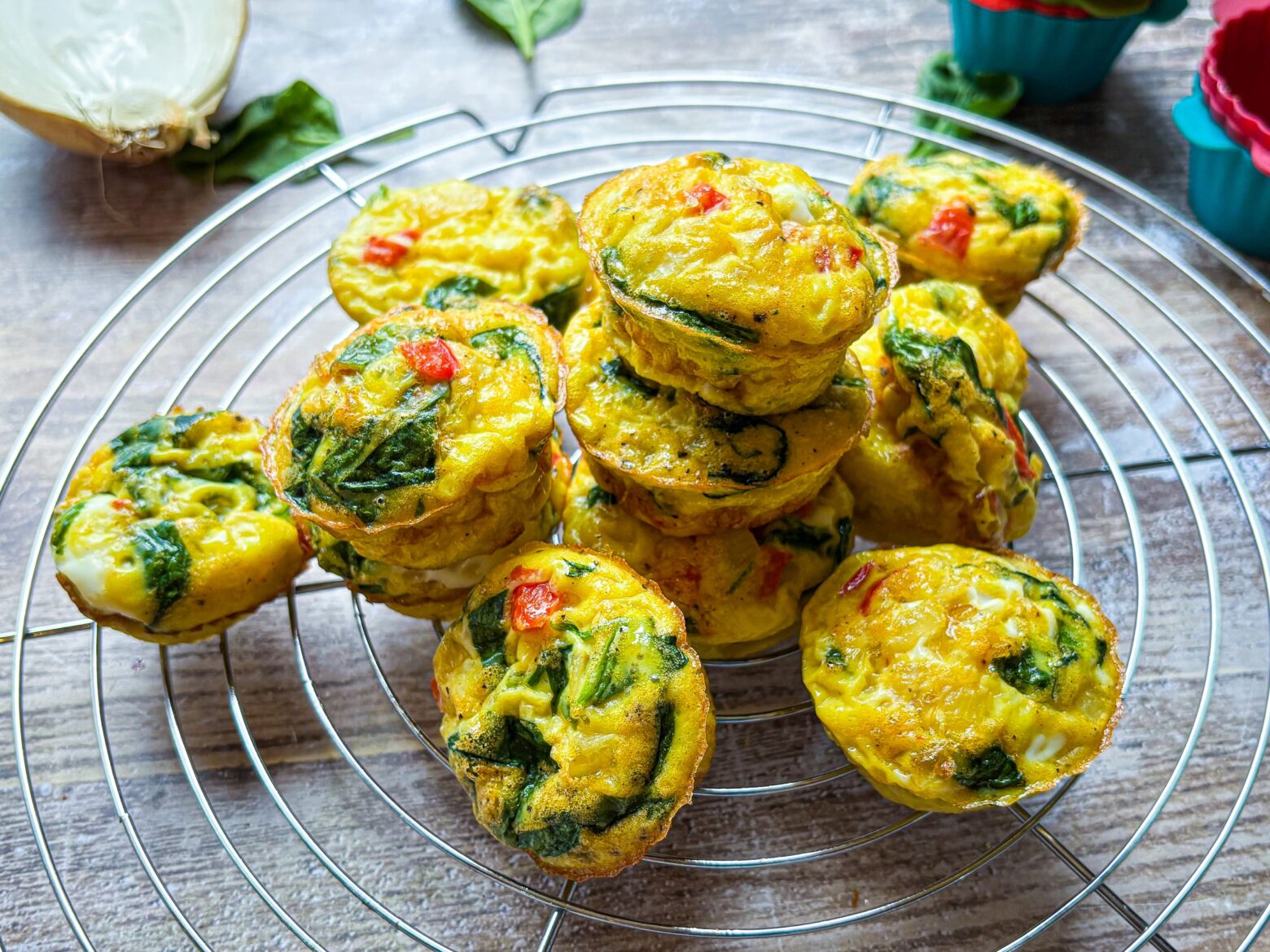 Red Pepper & Spinach Egg Bites stacked on a cooling rack.